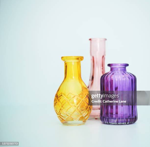 three glass vases arranged together on blue background - old fashioned glass stock pictures, royalty-free photos & images