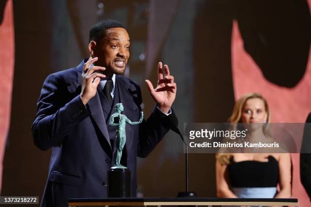 Will Smith accepts the Outstanding Performance by a Male Actor in a Leading Role award for ‘King Richard’ onstage from Reese Witherspoon during the...