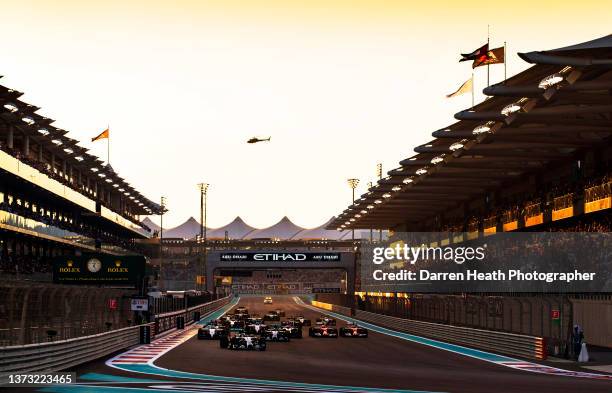 British Mercedes-AMG Formula One racing team racing driver Lewis Hamilton driving his silver F1 W05 racing car ahead of his German teammate Nico...