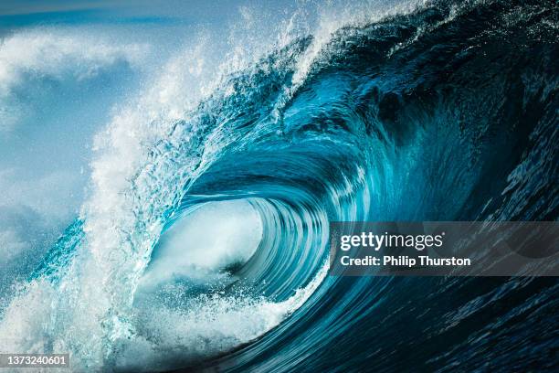 close up detail of powerful teal blue wave breaking in open ocean on a bright sunny afternoon - sea waves stock pictures, royalty-free photos & images