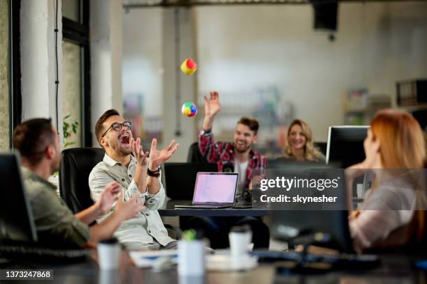 playful programmers having fun on a break in the office. - bedrijfscultuur stockfoto's en -beelden