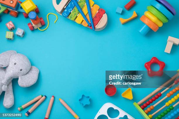 toddler toys frame with copy space on light blue background - toys background stock pictures, royalty-free photos & images