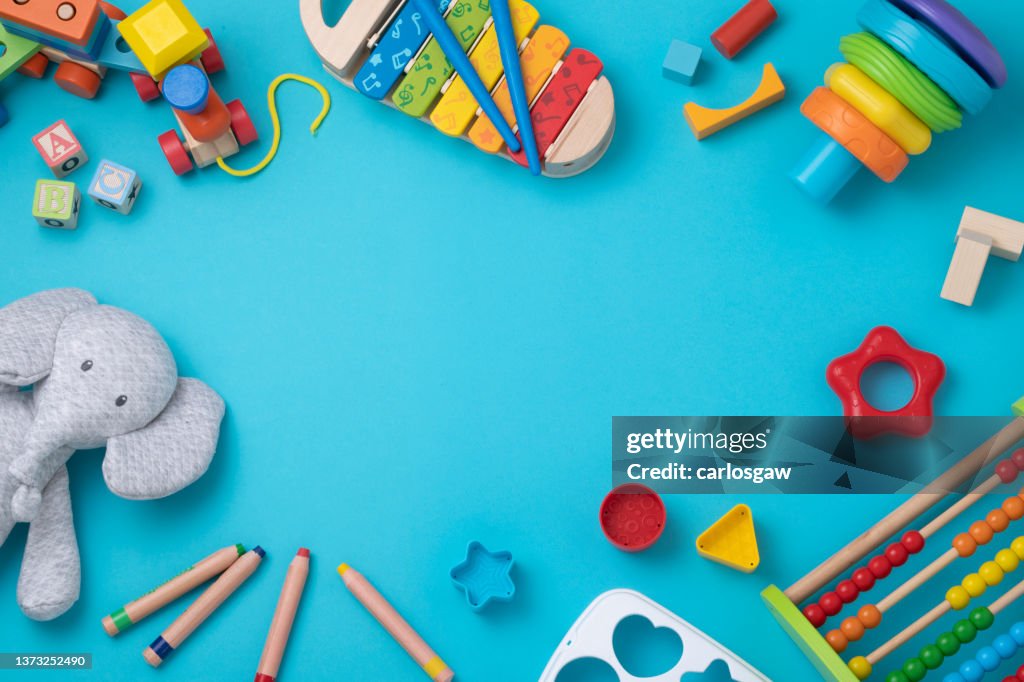 Toddler toys frame with copy space on light blue background