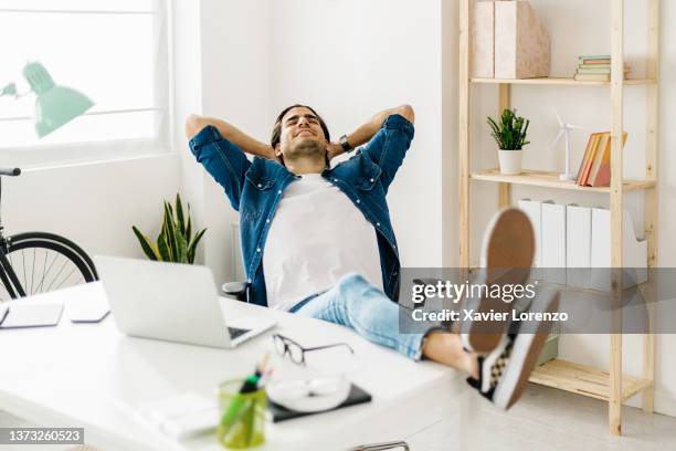 calm man resting and relaxing at the workplace during a break from the working day. - comfort zone ストックフォトと画像