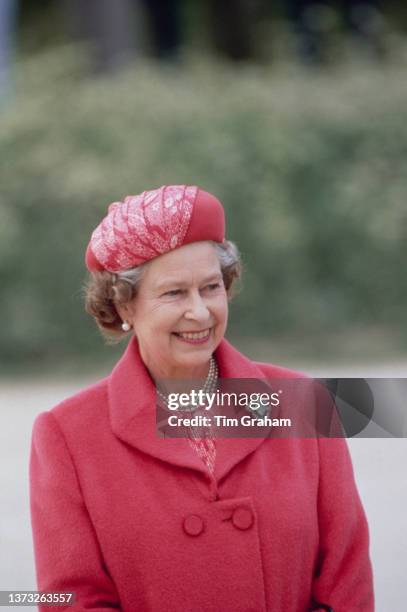 British Royal Queen Elizabeth II, wearing a pink John Anderson outfit and a matching hat, during a visit to inspect the troops of the 5th Airborne...