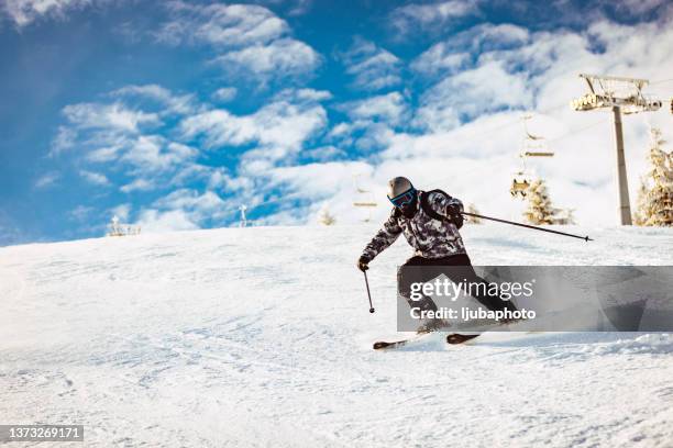 freeride skier at off-piste slope - mogul skiing stockfoto's en -beelden