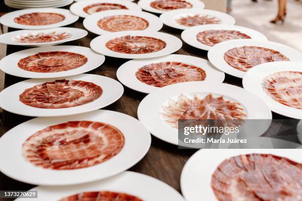 plates of freshly cut serrano ham - serrano ham foto e immagini stock