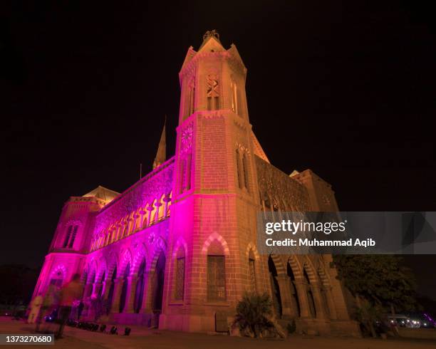 frere hall karachi illuminagted with pink lights - karachi city stock pictures, royalty-free photos & images