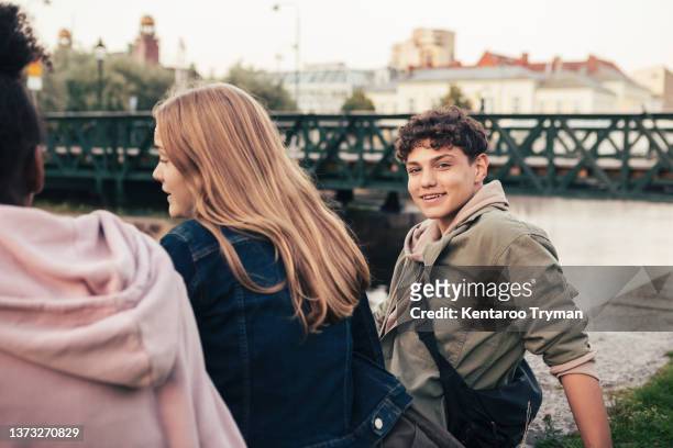 portrait of a teenage boy with his friends in a city environment - boys and girls town stockfoto's en -beelden