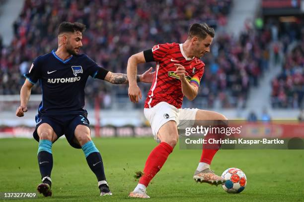 Christian Guenter of SC Freiburg challenges Marco Richter of Hertha BSC Berlin during the Bundesliga match between Sport-Club Freiburg and Hertha BSC...