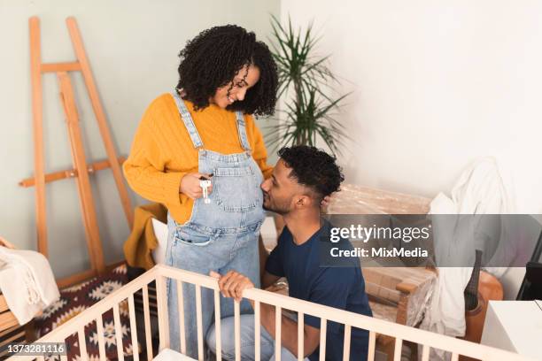 jeune couple heureux qui attend un bébé et profite de sa nouvelle maison - chambre bébé photos et images de collection