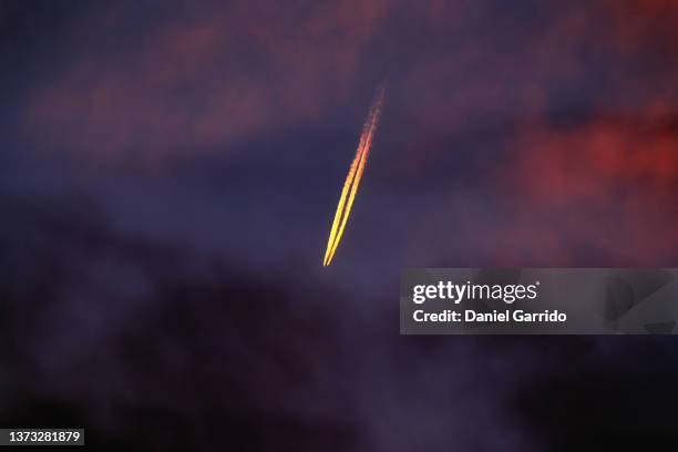 flying plane and its wake. aircraft background. space rocket.travel and vacation - sunset with jet contrails stock pictures, royalty-free photos & images