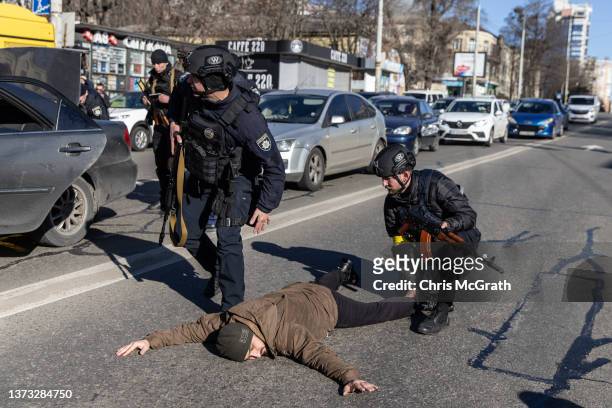 Police officers search a man at a checkpoint on February 28, 2022 in Kyiv, Ukraine. As Russia’s large-scale invasion of Ukraine entered its fifth...