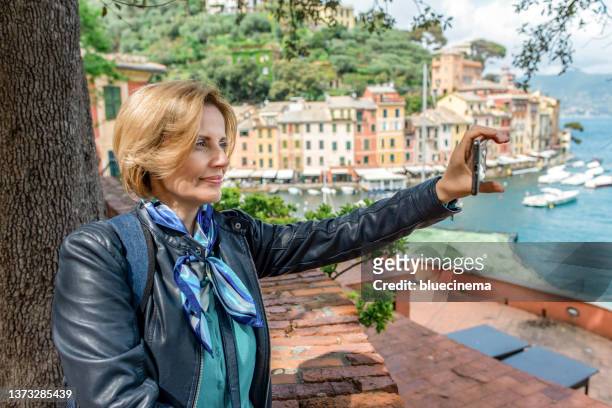 tourist in portofino making selfie - portofino stock pictures, royalty-free photos & images