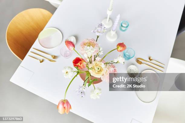 a modern spring bouquet with freesias, ranunculus and tulips in a beautiful vase - wearing flowers stock pictures, royalty-free photos & images