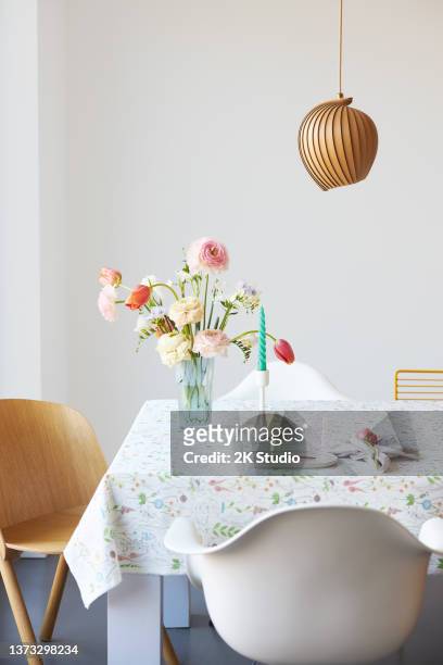 ein moderner frühlingsstrauß aus freesien, ranunkeln und tulpen in einer schönen vase - blumen als accessoire stock-fotos und bilder