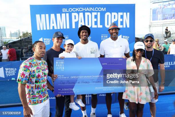 Ludacris, Wayne Boich, Jimmy Butler, and Alonzo Mourning pose with a check to Greater Miami Charities at Blockchain.com Miami Padel Open Finals...