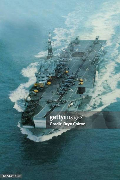 Hermes, a Royal Navy aircraft carrier leaves Portsmouth harbour for the Falkland War with Harrier jump jets and Sea King helicopters visible on the...