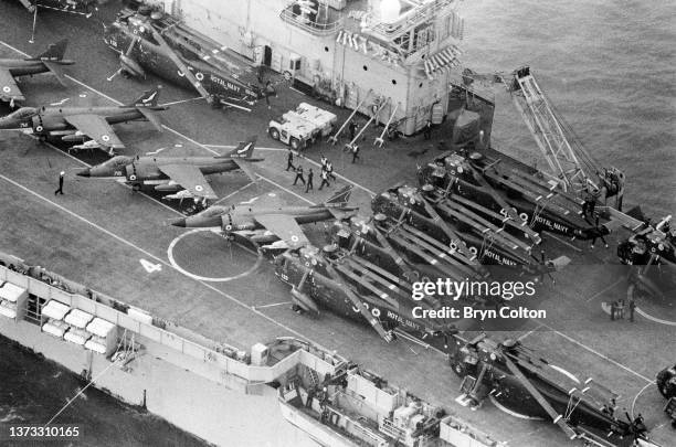 Hermes, a Royal Navy aircraft carrier leaves Portsmouth harbour for the Falkland War with Harrier jump jets and Sea King helicopters visible on the...