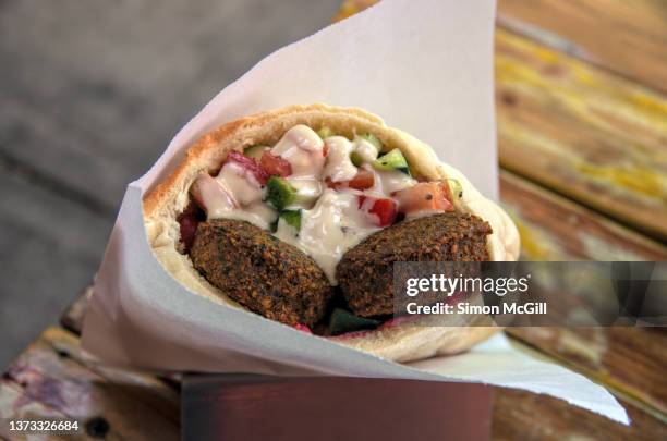 falafel and salad pita bread with yogurt sauce - falafel stock pictures, royalty-free photos & images