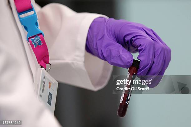 An analyst handles a vial of blood in the anti-doping laboratory which will test athlete’s samples from the London 2012 Games on January 19, 2012 in...