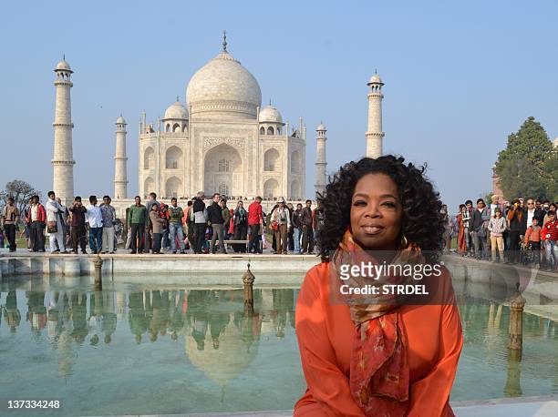 Talk show host Oprah Winfrey poses in front of the Taj Mahal on January 19, 2012. Winfrey is on her first visit to the country to film an episode of...