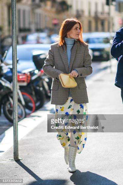Guest wears a pale blue ribbed turtleneck pullover, a beige / brown / black / blue checkered print pattern blazer jacket, a pale yellow shiny leather...