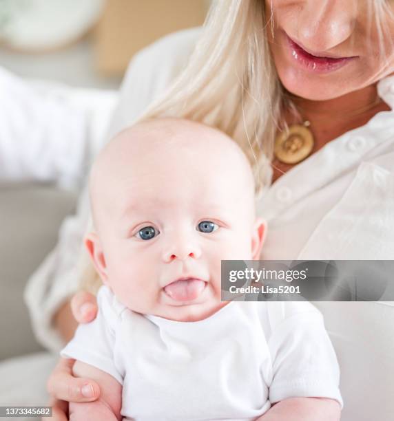silly three month old adorable baby boy sticks out his tongue, making a cute funny face - eye color stock pictures, royalty-free photos & images