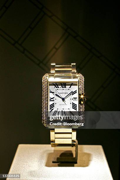 Tank Anglaise wristwatch by Cartier, a watchmaking unit of Cie. Financiere Richemont SA, sits on display at the Salon International de la Haute...