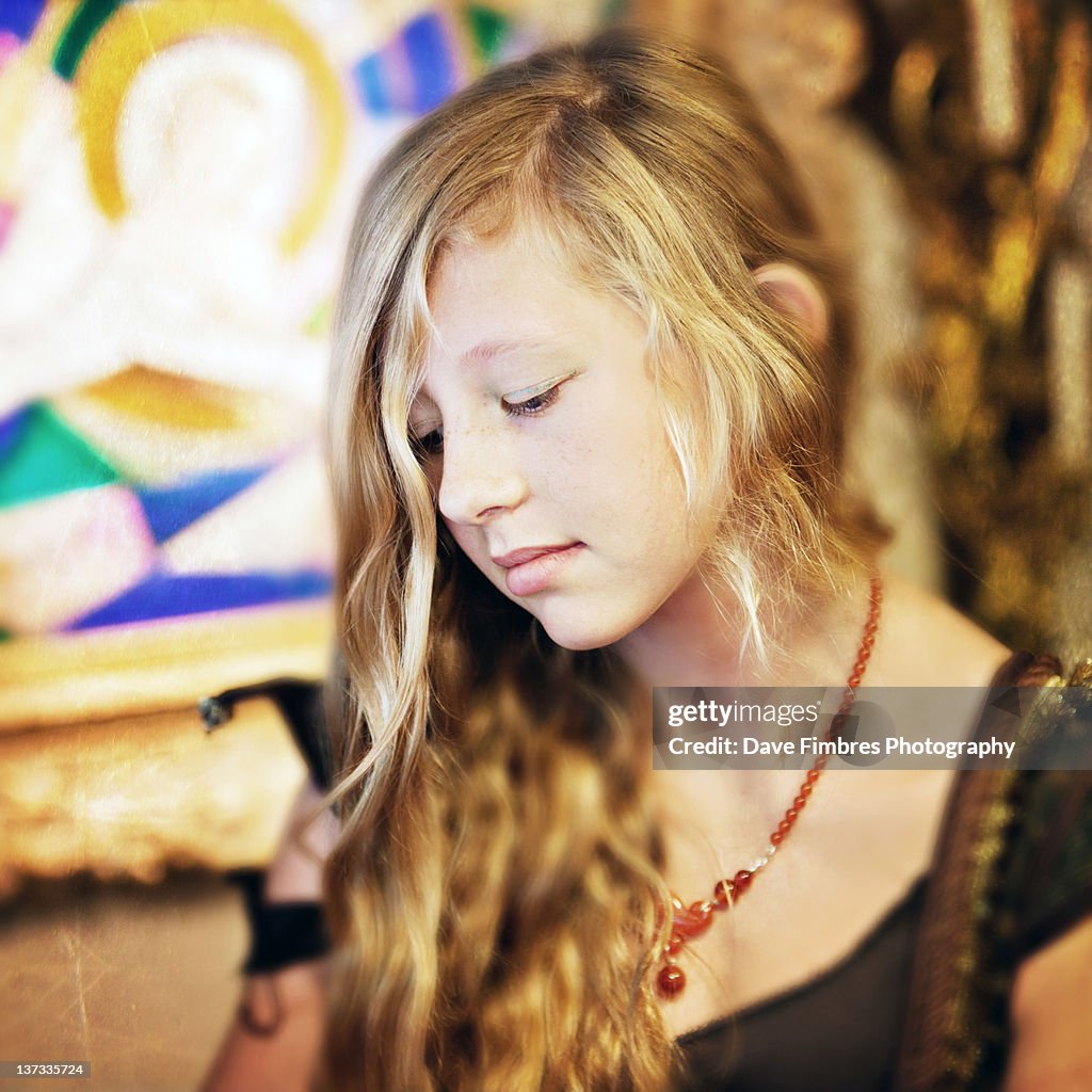 Very pretty blond girl in contemplative pose