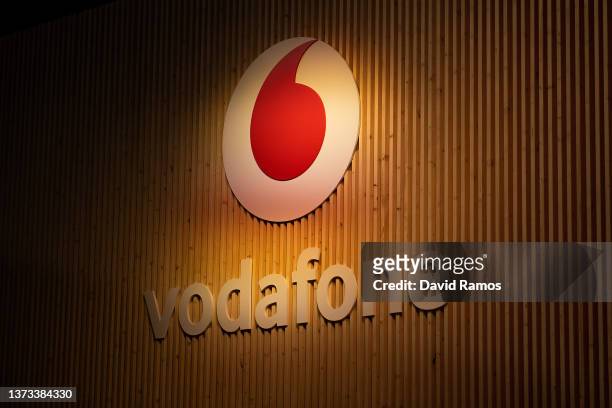 Logo sits illuminated outside the Vodafone booth at the SK telecom booth on day 1 of the GSMA Mobile World Congress on February 28, 2022 in...
