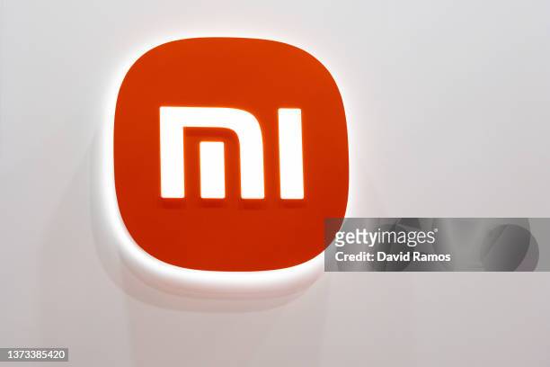 Logo sits illuminated outside the Xiaomi booth at the SK telecom booth on day 1 of the GSMA Mobile World Congress on February 28, 2022 in Barcelona,...