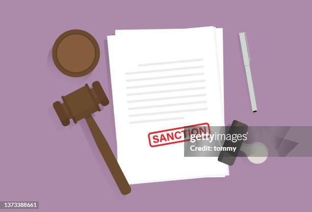 document with a sanction sign, pen, rubber stamp, and a gavel on the table - penalty stamp stock illustrations