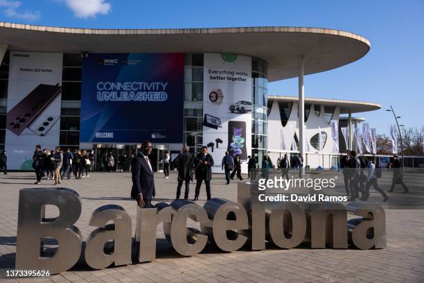 Visitor poses for a picture outside the venue on day 1 of the GSMA Mobile World Congress on February 28, 2022 in Barcelona, Spain. The annual Mobile...