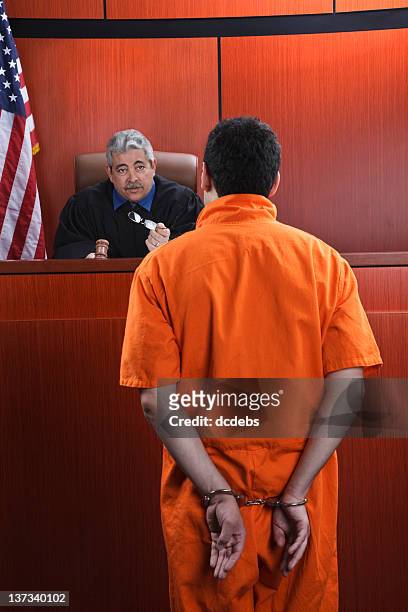 judge speaks to prisoner in courtroom - handcuffs bildbanksfoton och bilder