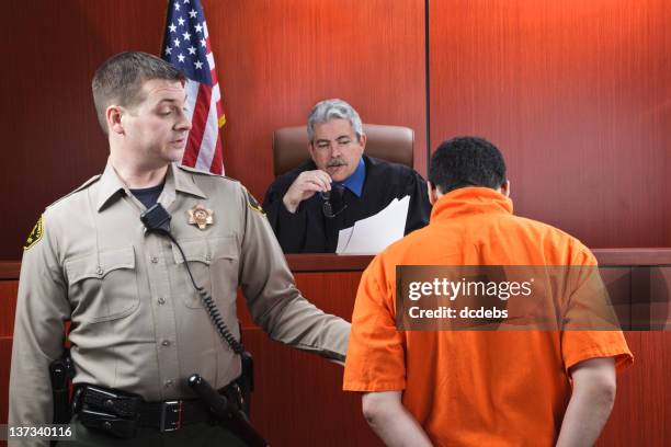 judge and prisoner in courtroom - serious crimes court stock pictures, royalty-free photos & images