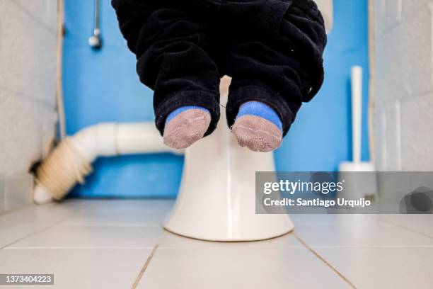 young boy sitting on toilet - potty training stock pictures, royalty-free photos & images