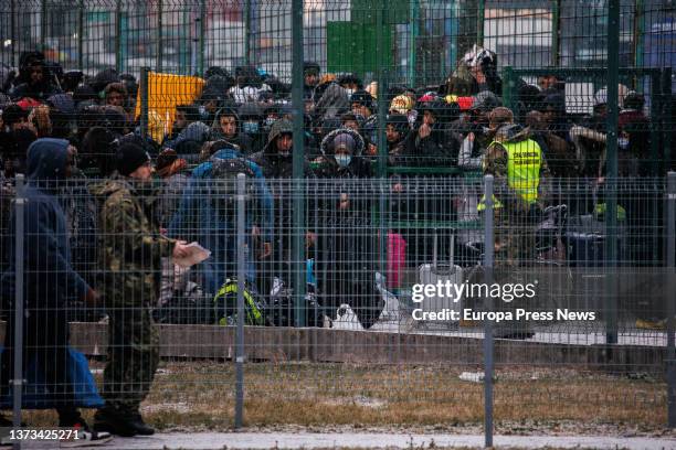 People wait behind a gate to enter Poland at the Medyka border crossing on February 28 in Medyka, Poland. It takes Ukrainians two to three days to...