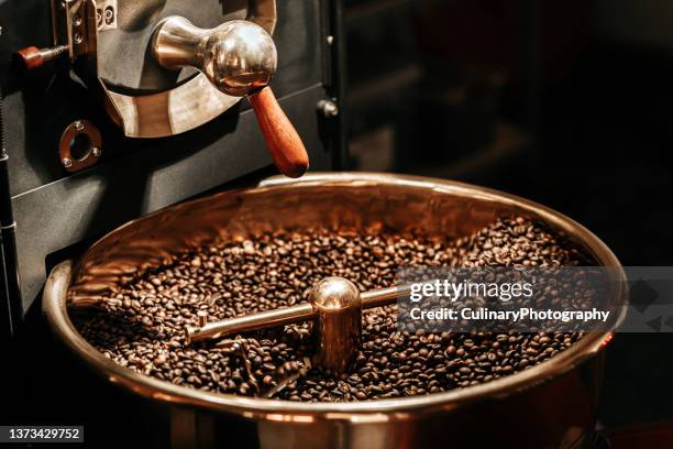 coffee beans being cooled after being roasted from a coffee roaster machine - coffee roasting machines stock pictures, royalty-free photos & images