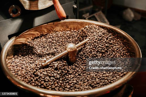 coffee beans being cooled after being roasted from a coffee roaster machine - arabica coffee drink stock pictures, royalty-free photos & images