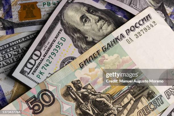 100 us dollar and 50 russian ruble banknotes - russian rouble note stock pictures, royalty-free photos & images