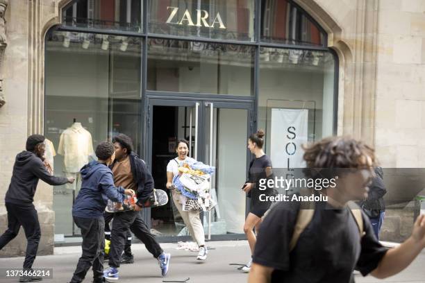 Protesters plundering restaurants and shops during a protest against the death of 17-year-old Nahel, who was shot in the chest by police in Nanterre...