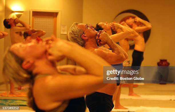 The atmosphere was red hot as the participants were sweating as the temperature is near 100 degrees at a class at the Bikram Yoga location in the...