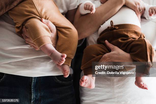 close up of baby legs and feet in parents' hands - in vitro fertilization stock pictures, royalty-free photos & images