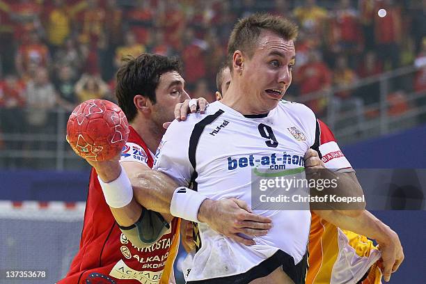 Filip Mirkulovski of Macedonia defends against Filip Jicha of Czech Republic during the Men's European Handball Championship group B match between...