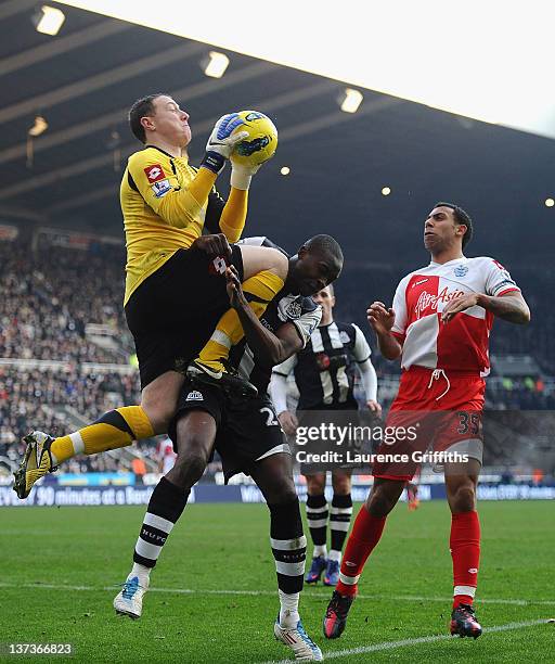 Paddy Kenny of Queens Park Rangers claims the ball from Shola Ameobi of Newcastle United during the Barclays Premier League match between Newcastle...