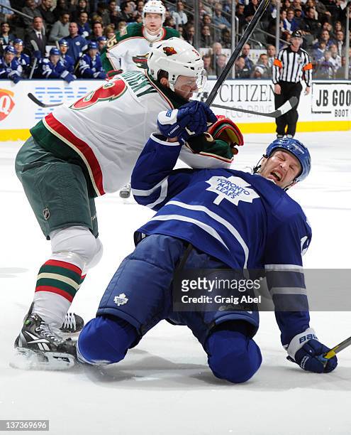 Tim Connolly of the Toronto Maple Leafs is checked to the ice by Marek Zidlicky of the Minnesota Wild during NHL game action January 19, 2012 at Air...