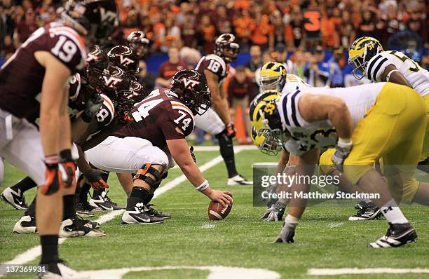 Andrew Miller of the Virginia Tech Hokies readies to snap the at the line of scrimmage on offense against the Michigan Wolverines during the Allstate...