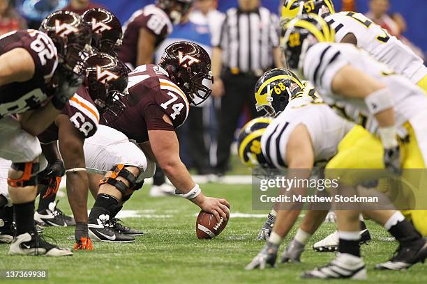 Andrew Miller of the Virginia Tech Hokies readies to snap the at the line of scrimmage on offense against the Michigan Wolverines during the Allstate...