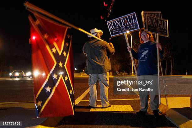 Jonny Whiting and his son Tyler Whiting show their support for Ron Paul as their preferred Republican presidential candidate before the start of a...